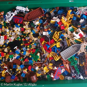Auf dem Bild ist zu sehen, welche Minifiguren und Dekoelemente in den Bibelkisten enthalten sind.